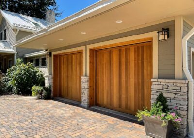 Home garage doors with surrounding siding freshly painted