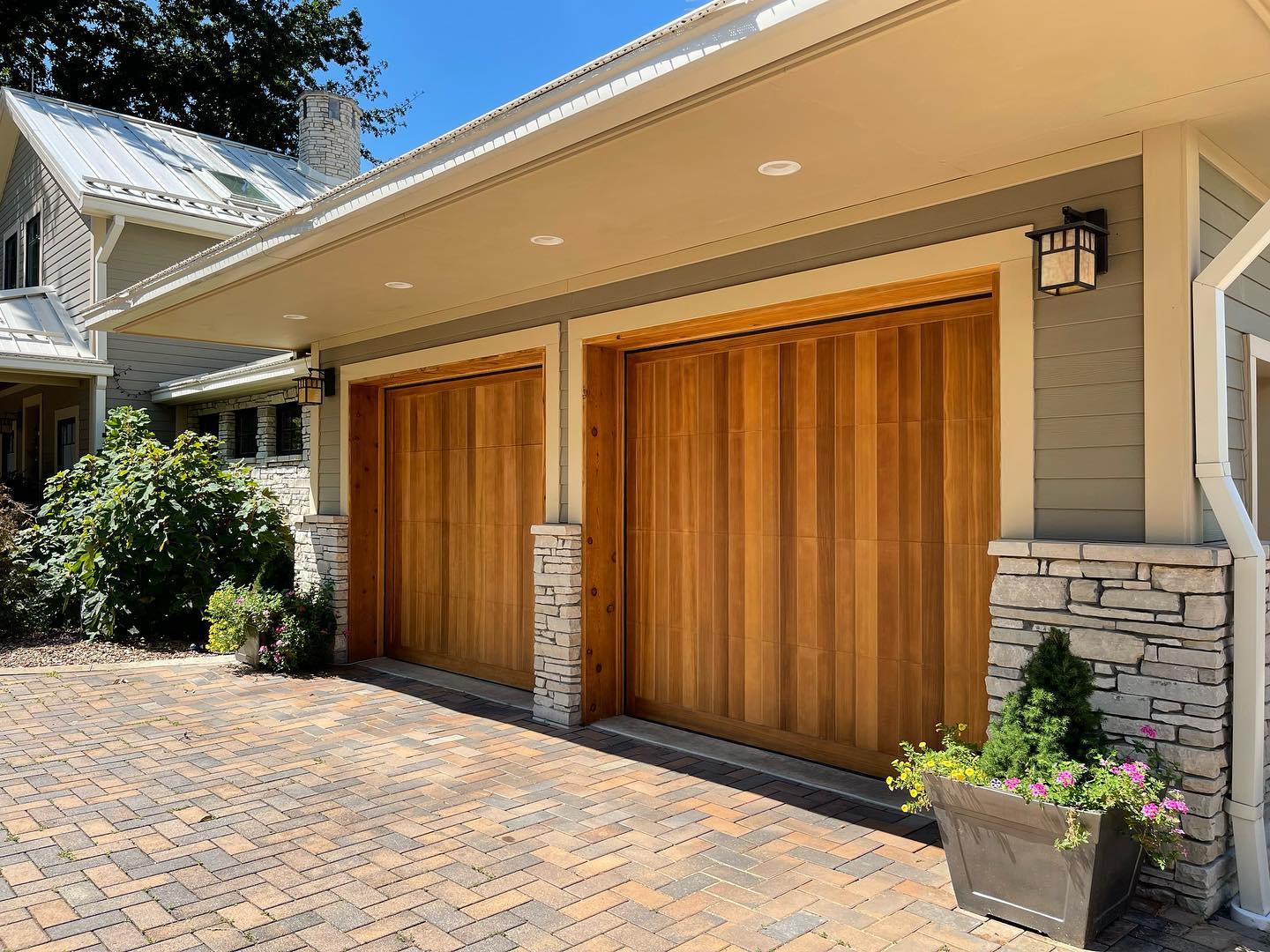 Home garage doors with surrounding siding freshly painted