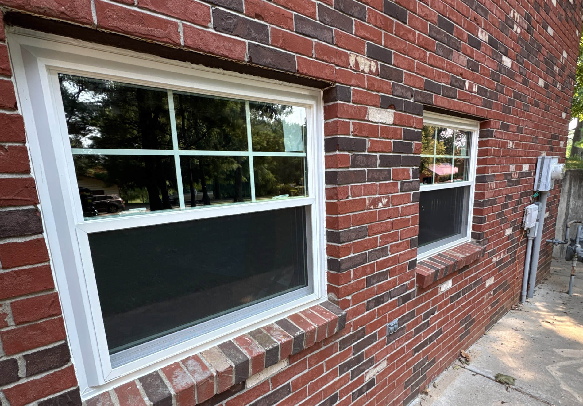 Installed window on brick home